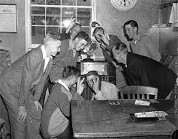 Group gathered around office radio, VJ Day, 1945. | Minnesota Historical  Society